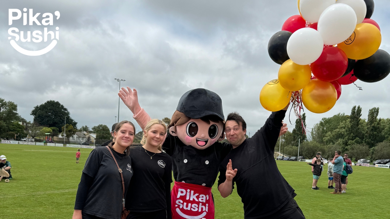 woman & man with pika sushi mascot at park