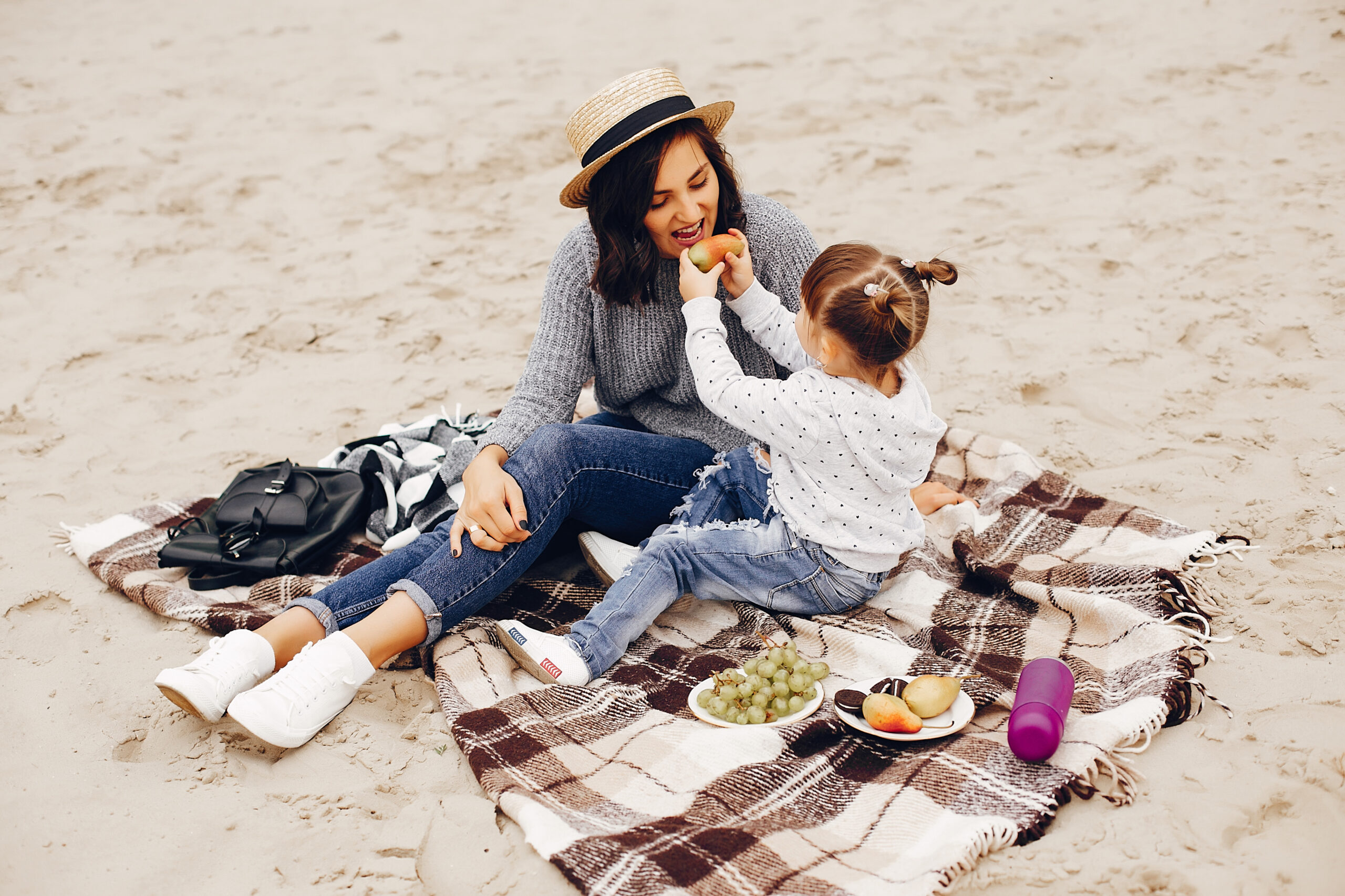 Mother with daughter playing in a summer park